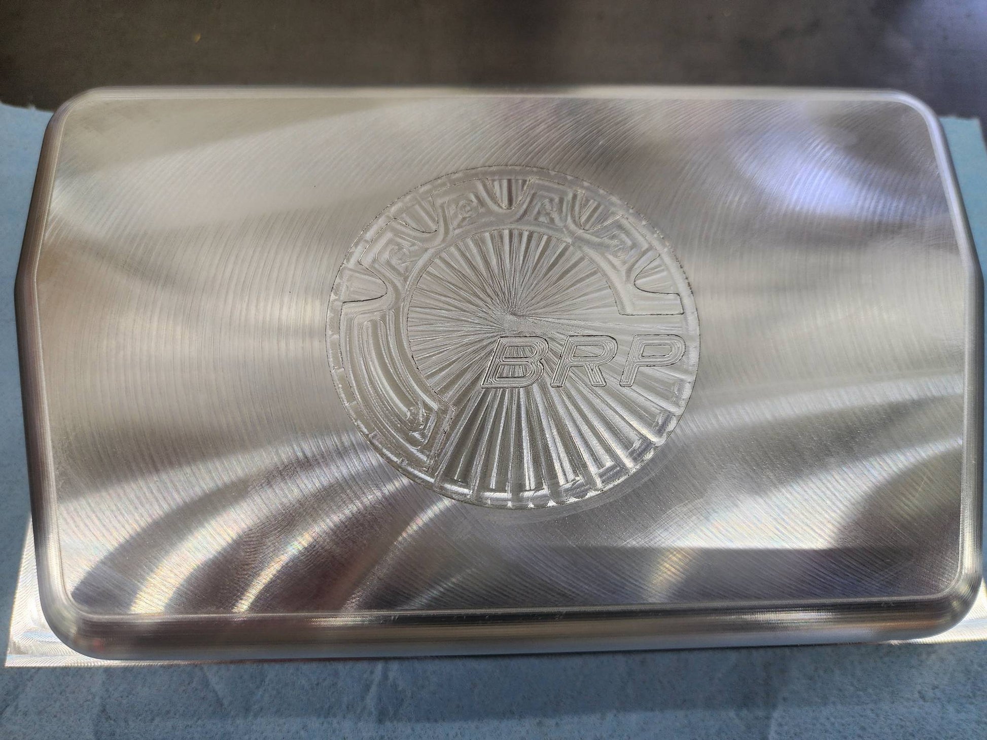 Billet Rugged Radio cover with BRP logo in raw aluminum finish
