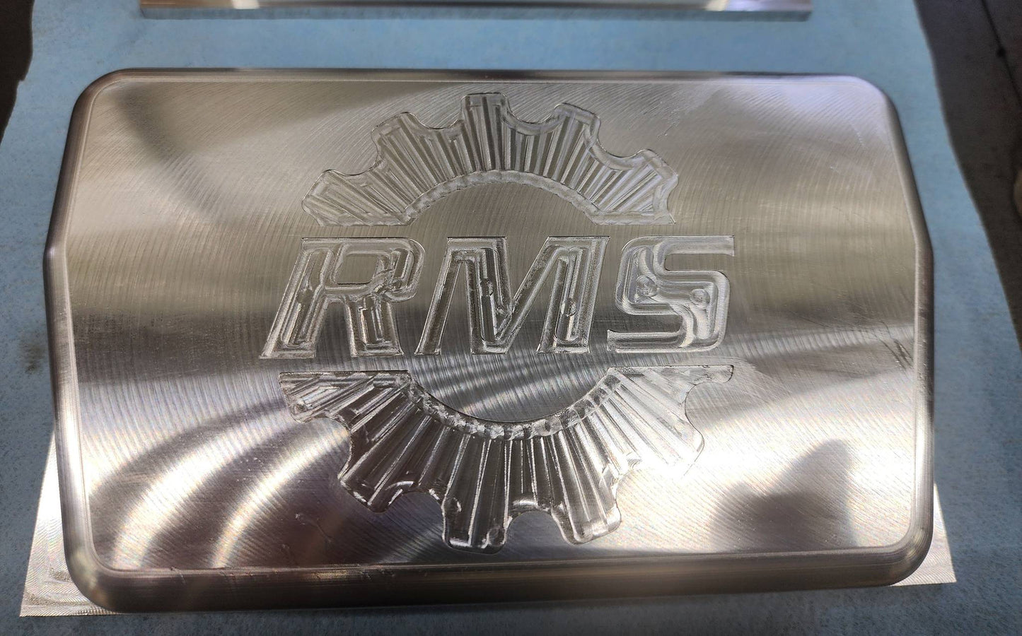 Billet Rugged Radio cover with RMS logo in raw aluminum finish