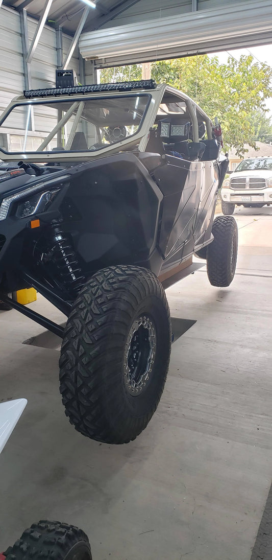 Can -Am X3 XRS Max on lift in garage for maintenance 