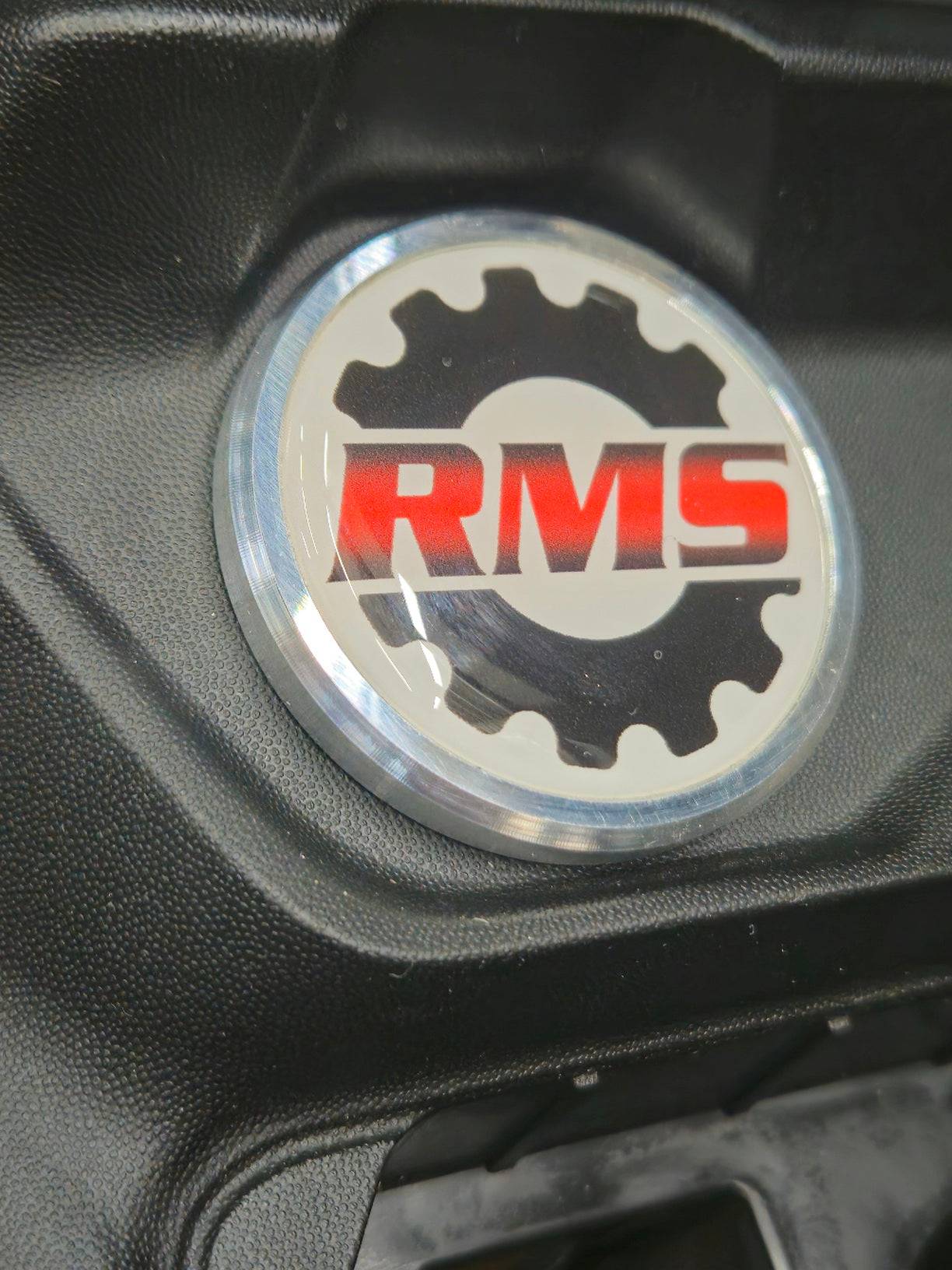 Billet Push to start button for maverick r, with logo design, closeup. 